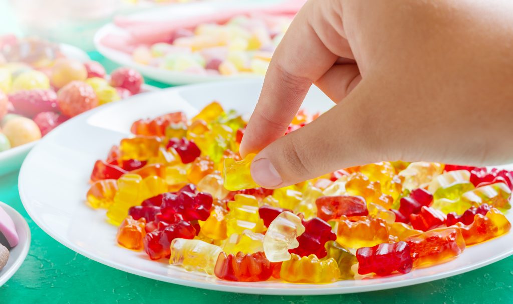hand-takes-colorful-gummy-bears-candies